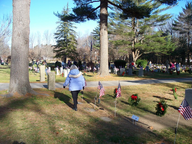 People placing wreaths